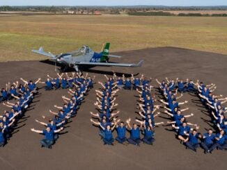 Equipo de Embraer celebrando la entrega del Ipanema número 1.700 junto a un avión EMB-203 en plataforma