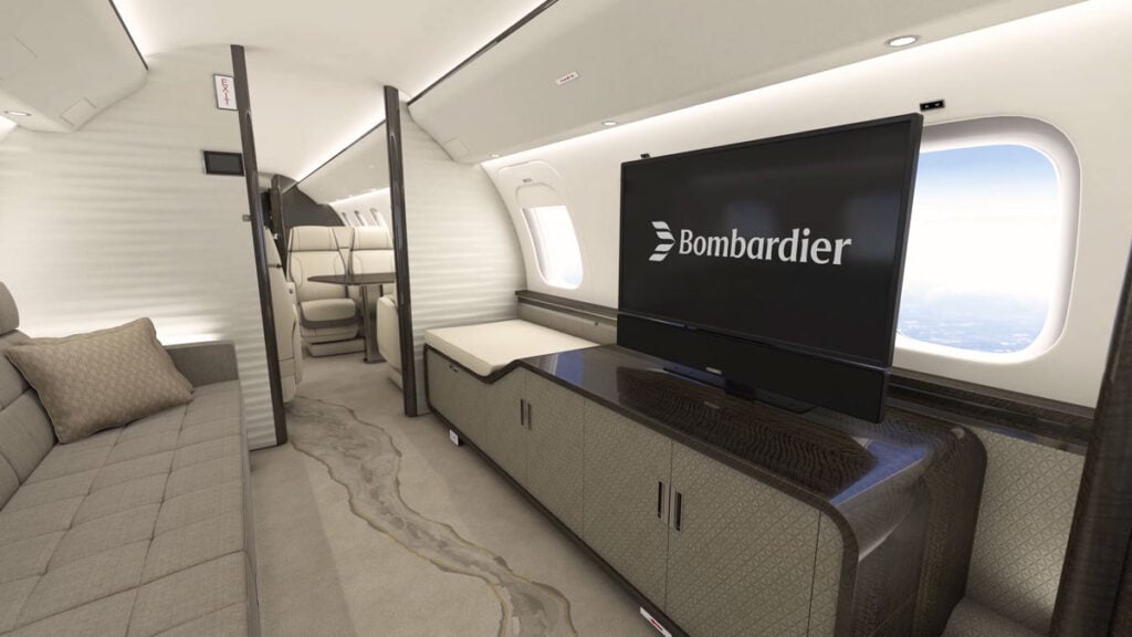 Cabina de entretenimiento del Bombardier Global 8000 con pantalla retráctil y área de descanso.