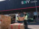 Personal operativo gestionando envíos de mercancías frente al centro logístico de SKY Carga.