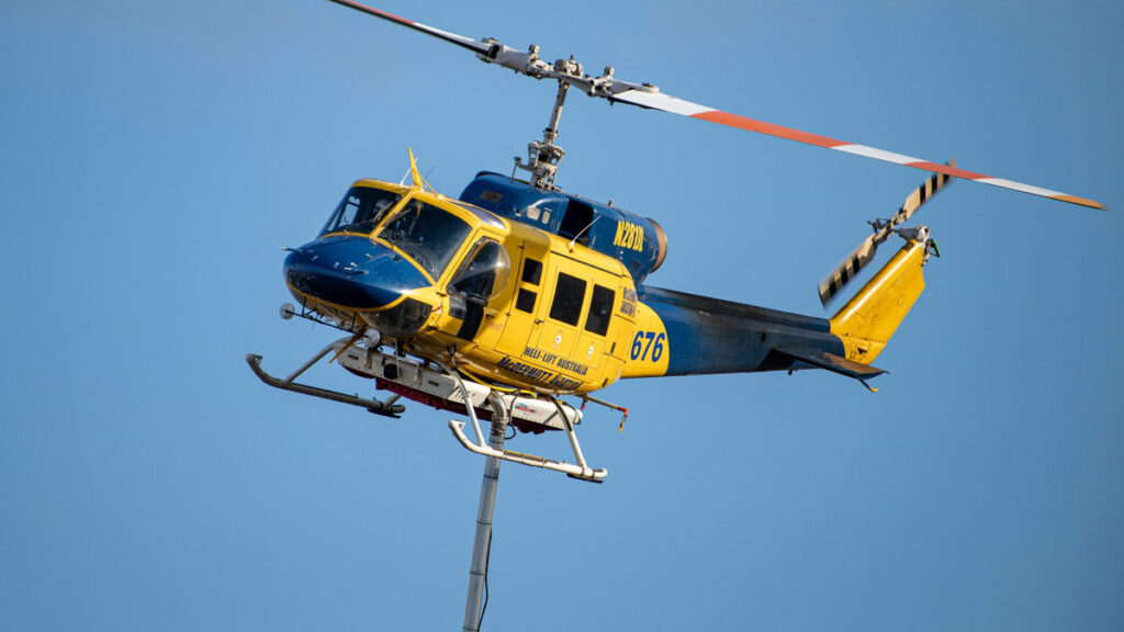 Helicóptero Bell 214ST de McDermott Aviation en pleno vuelo realizando una misión de carga suspendida. Entrol desarrollará un simulador específico para este modelo enfocado en la extinción de incendios.