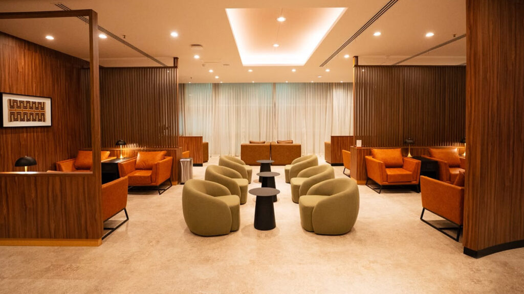 Vista interior de la nueva sala VIP de AMAE Lounge en el sector de cabotaje del Aeropuerto de Ezeiza, destacando sillones de diseño y paneles de madera